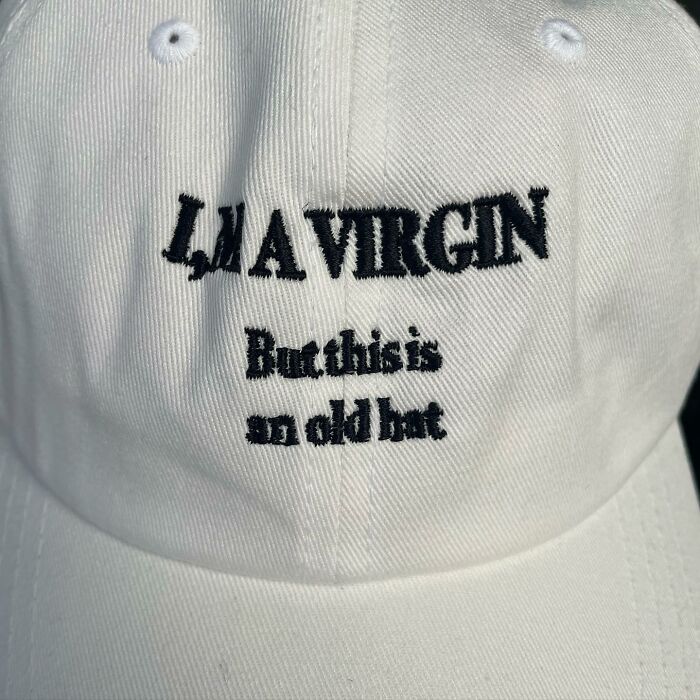 White cap with humorous text showcasing translation mishap.