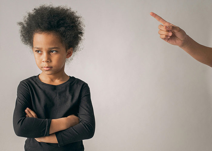 Child looking upset as an adult points accusingly, highlighting worst teachers moments.