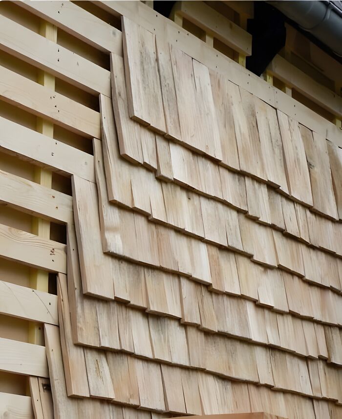 Close-up of wooden siding showing layered wooden planks as a woodworking ideas project with natural wood texture.