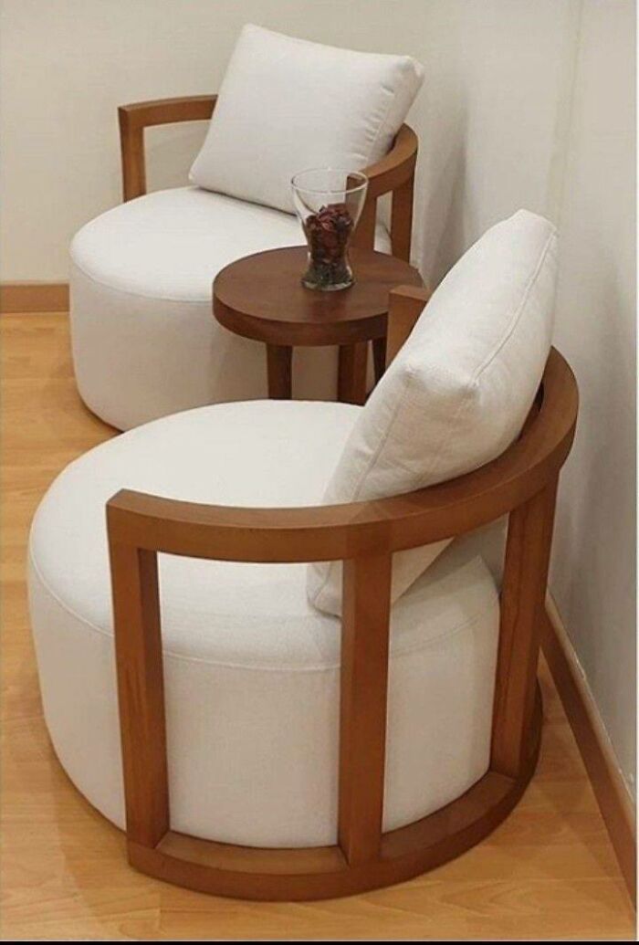Modern wooden chairs with white cushions and a small round wooden table, showcasing creative woodworking ideas.
