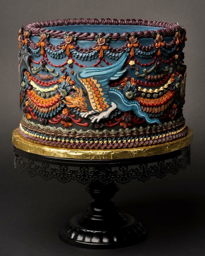 A visually stunning cake adorned with intricate bug and slug designs, featuring rich colors and detailed patterns.