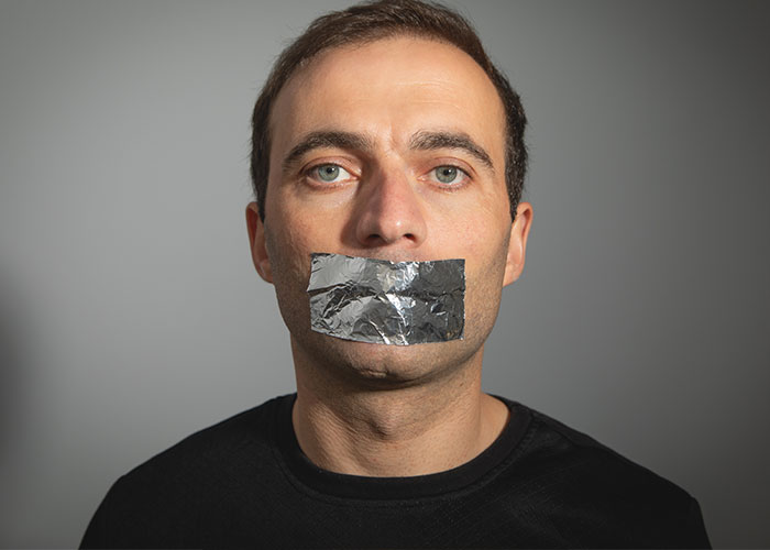 Man with tape over mouth, illustrating unrealistic movie scenes.