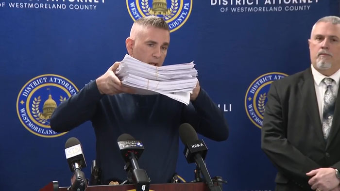District Attorney holds papers at a press conference related to a TikTok predator investigation. District Attorney holds papers at a press conference related to a TikTok predator investigation.