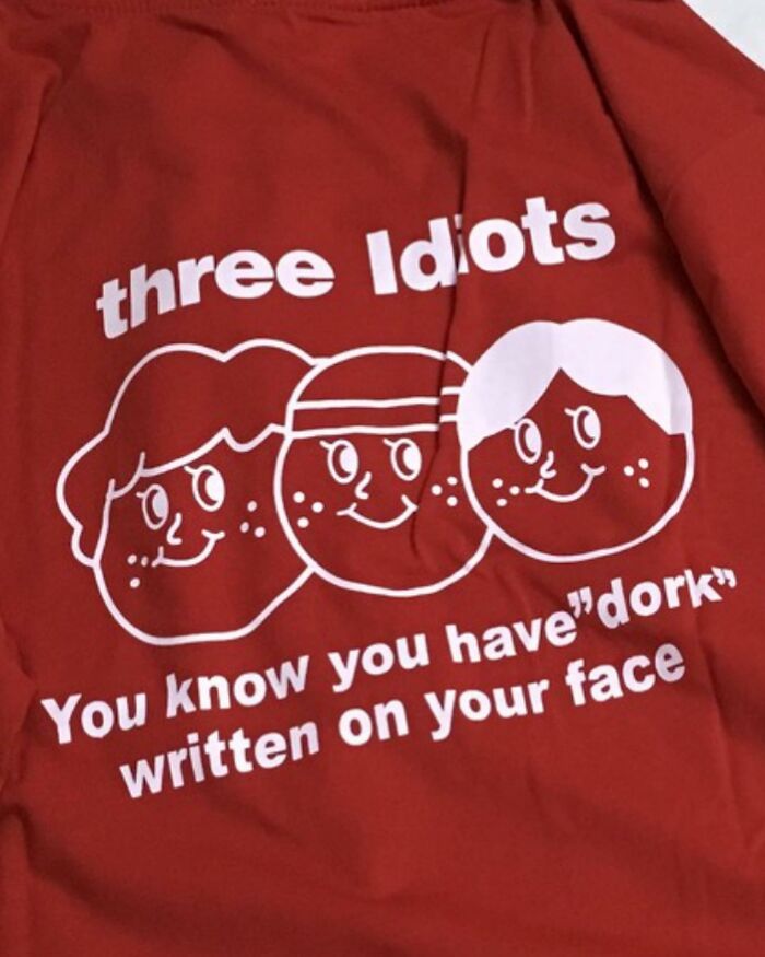 Red T-shirt with a funny design saying "three Idiots" and "You know you have 'dork' written on your face."