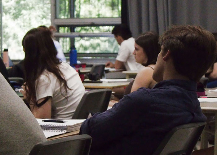 Students in a classroom setting, focusing on a lesson, representing challenges faced with ineffective teachers.