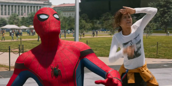 Spider-Man in costume with woman shielding her eyes looking up in a park illustrating things that look awesome in movies but are terrible in real life.