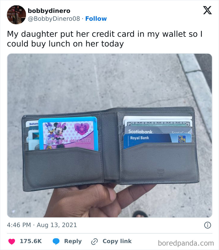 Wallet filled with credit cards and a humorous parenting meme about a child giving their dad a credit card for lunch.