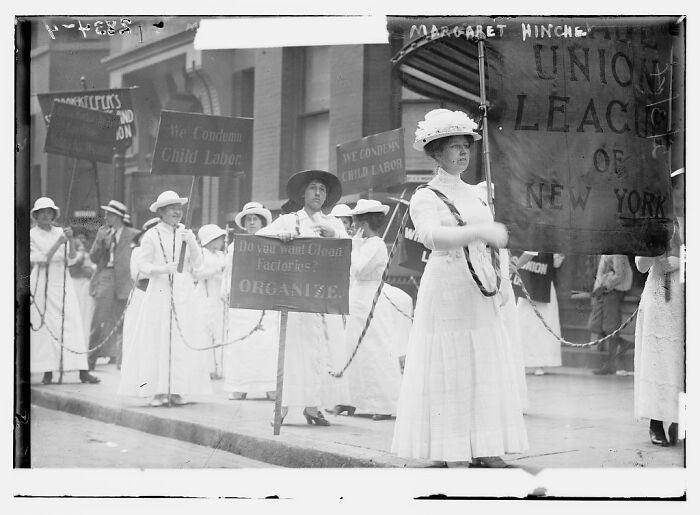 Women in early 20th-century clothing protesting child labor and cigar factories in a rare photograph restored from glass negatives.