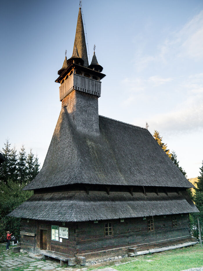 Traditional wooden church with steep, shingled roof, representing lesser-known architectural wonders.