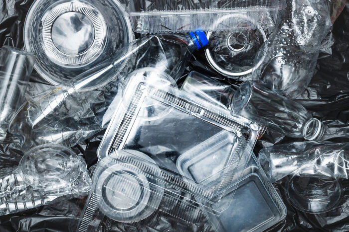 Plastic waste and containers on a black background, highlighting overlooked science issues.
