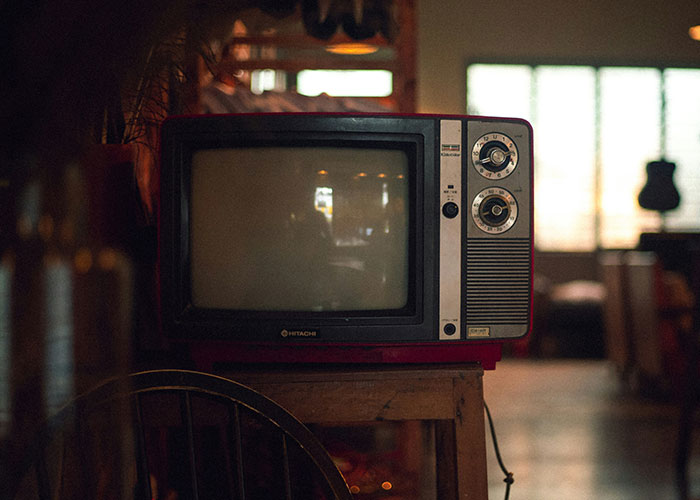 Vintage TV set in a dimly lit room, evoking nostalgia and mystery of wild rumors come true.