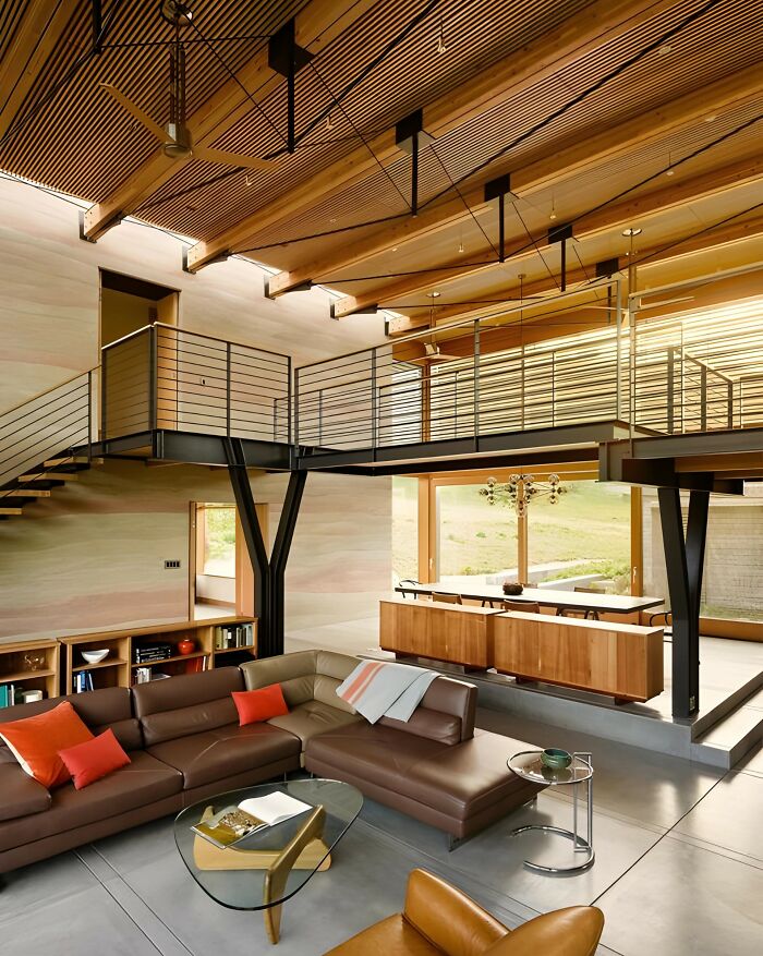 Modern living room featuring wood ceiling beams, wooden furniture, and a sleek glass coffee table showcasing woodworking ideas.