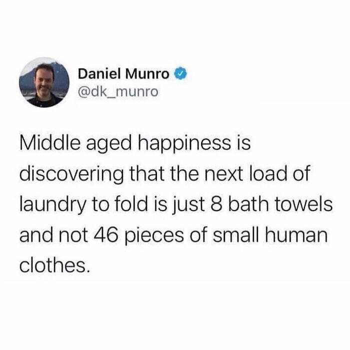 Relatable parenting meme about laundry, highlighting the joy of folding fewer towels instead of many kids' clothes.