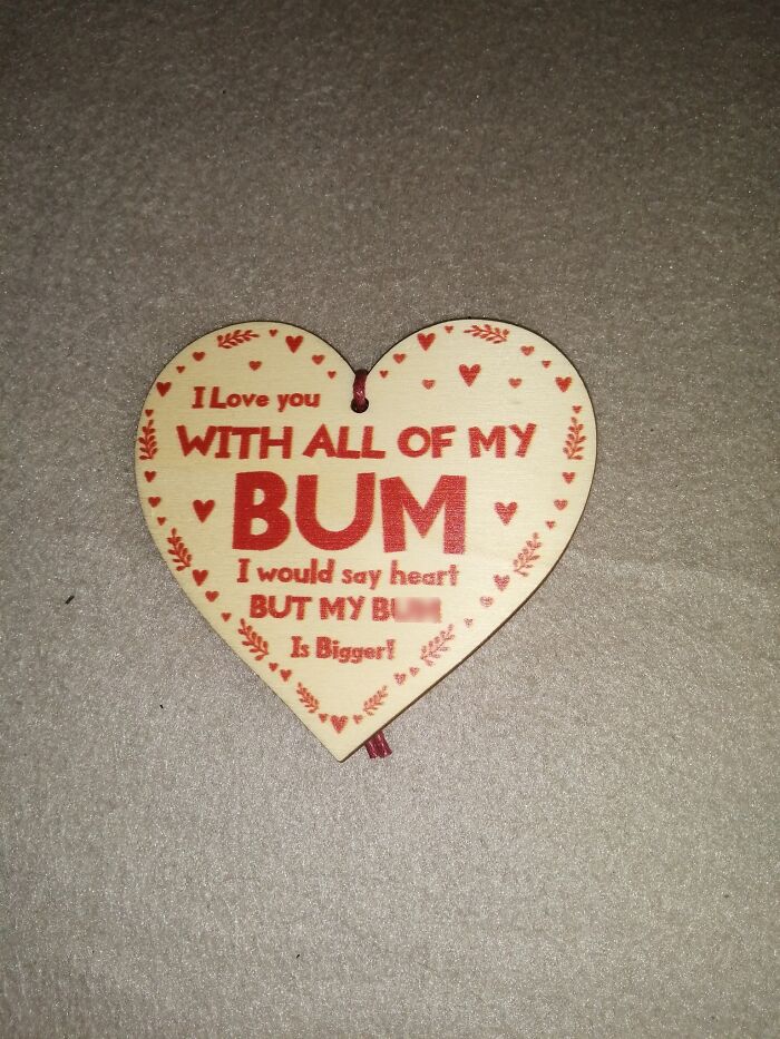 Heart-shaped wooden sign with humorous message found in a secondhand shop.