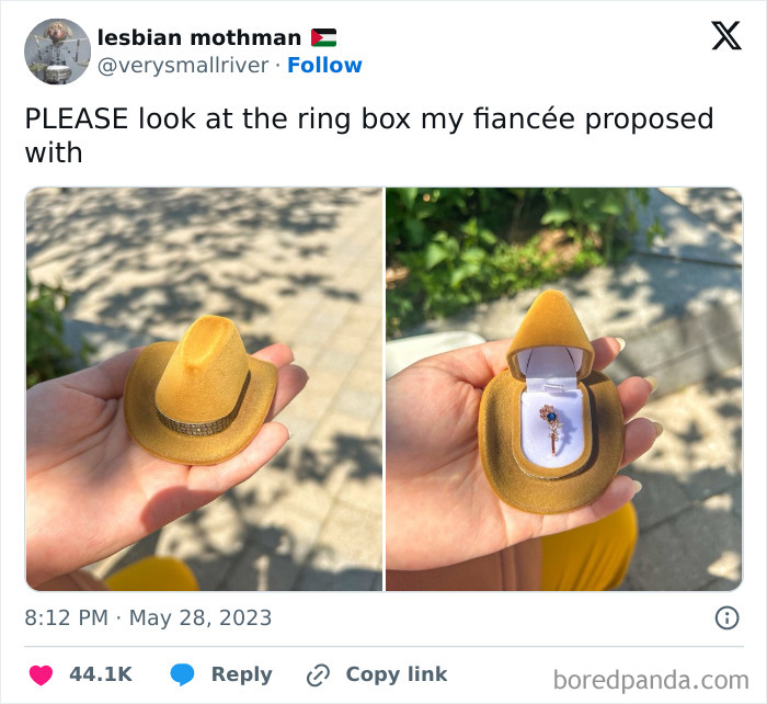 Hand holding a tiny yellow cowboy hat ring box with a delicate key-shaped ring inside, capturing pure and uplifting moments.