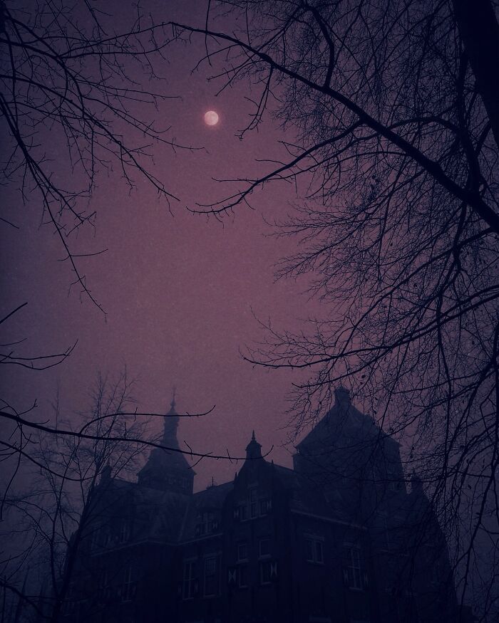 Dark, foggy scene of a gothic building silhouetted against the moon, illustrating dreamy escapism photography.