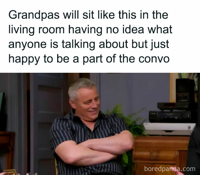 Man in striped shirt sitting in a living room with a smile, featured in a relatable parenting meme.