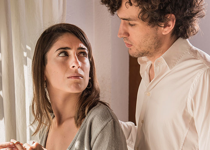 Man and woman in a tense moment, capturing emotion and discomfort, illustrating a scene from "Asked For A Duke Dennis Hug".