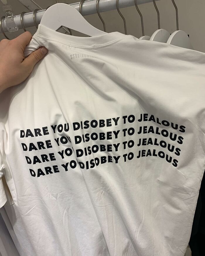 White t-shirt with humorous mistranslation repeated: "Dare you disobey to jealous."