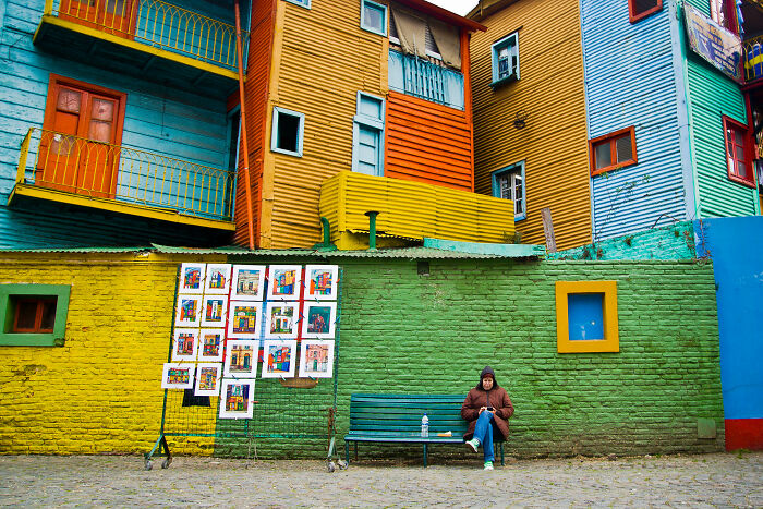 Colorful buildings with vibrant walls and art display, resembling a real-life painting in a vibrant city scene.