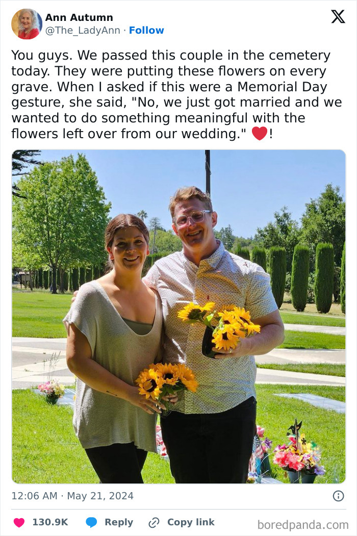 Couple placing wedding flowers on graves in cemetery, sharing a pure and uplifting moment on a sunny day.