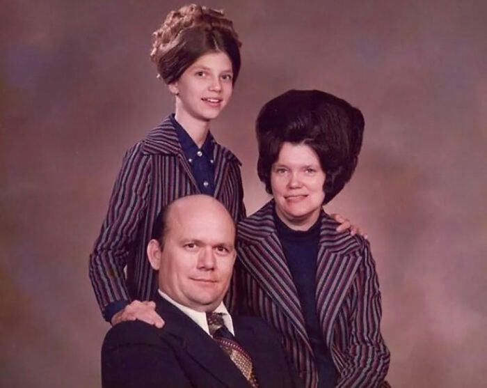 Family portrait with vintage hairstyles and striped suits, showcasing absurd and amazing styles from yesteryear.