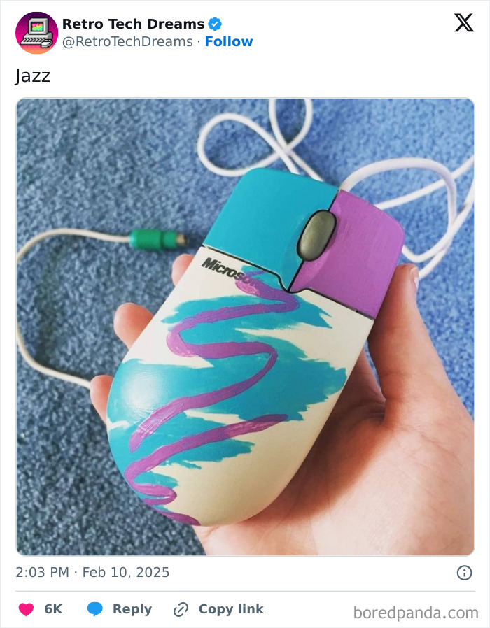 Vintage Microsoft mouse with colorful '90s design held in hand, representing retro technology nostalgia.