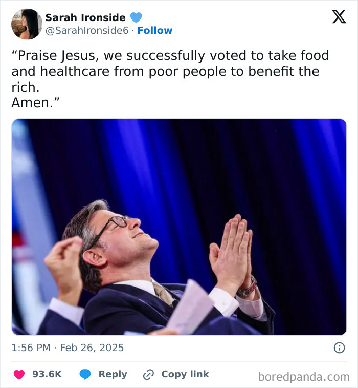 Man in suit with glasses clasping hands in mock prayer at an event, symbolizing facepalm moments.
