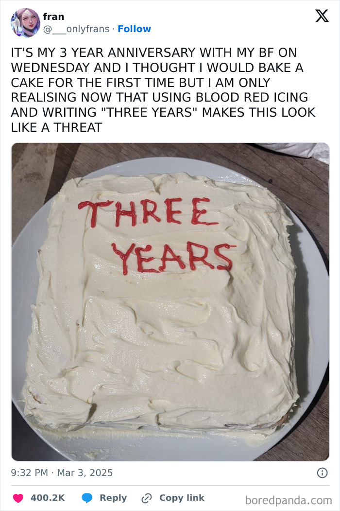 Cake with "THREE YEARS" in red icing, humorously resembling a threat, capturing a bad day moment.