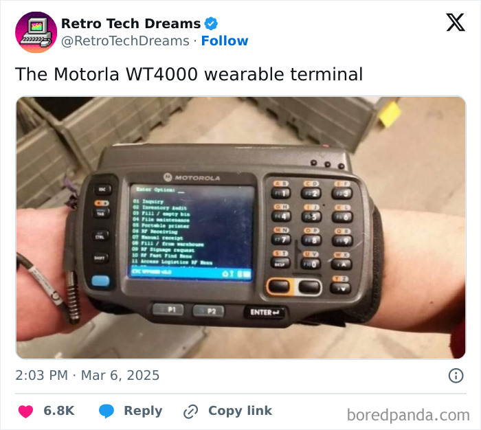 Motorola WT4000 wearable terminal on a wrist, showcasing retro technology with a digital display and keypad.