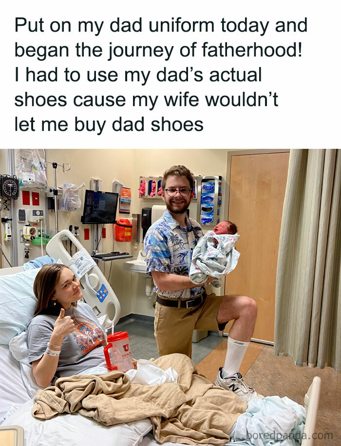 Father in a Hawaiian shirt and shorts in a hospital, humorously embracing new parenting with dad shoes.