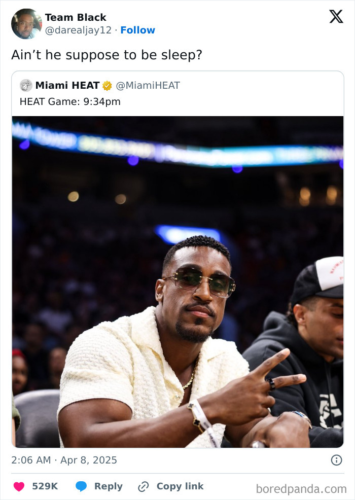 Man making peace sign at Miami HEAT game, sunglasses on, captioned with a funny tweet about staying awake.