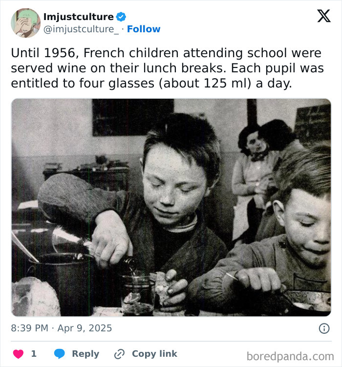 Children in 1950s France served wine at school lunch, drinking from small glasses.