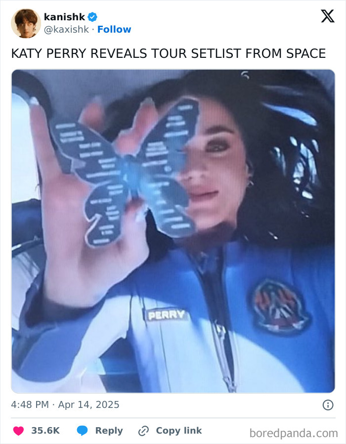 Performer in space holding a butterfly card, wearing a blue space suit labeled "Perry," for a galactic PR stunt.