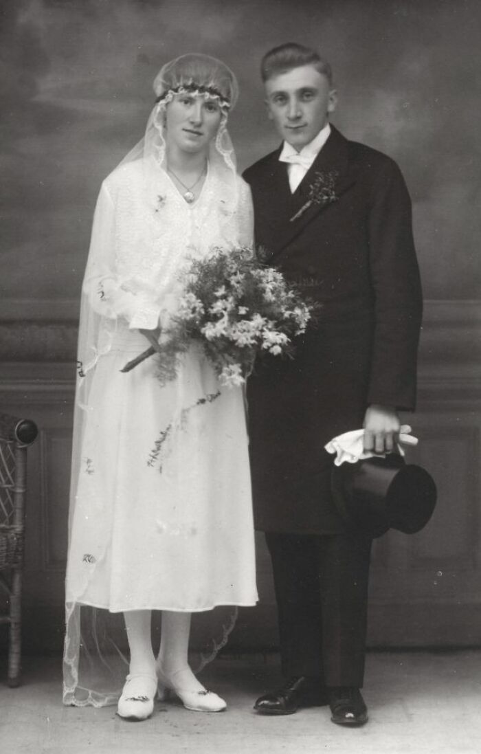 Vintage wedding photo featuring a bride and groom in classic attire, capturing timeless love and style.