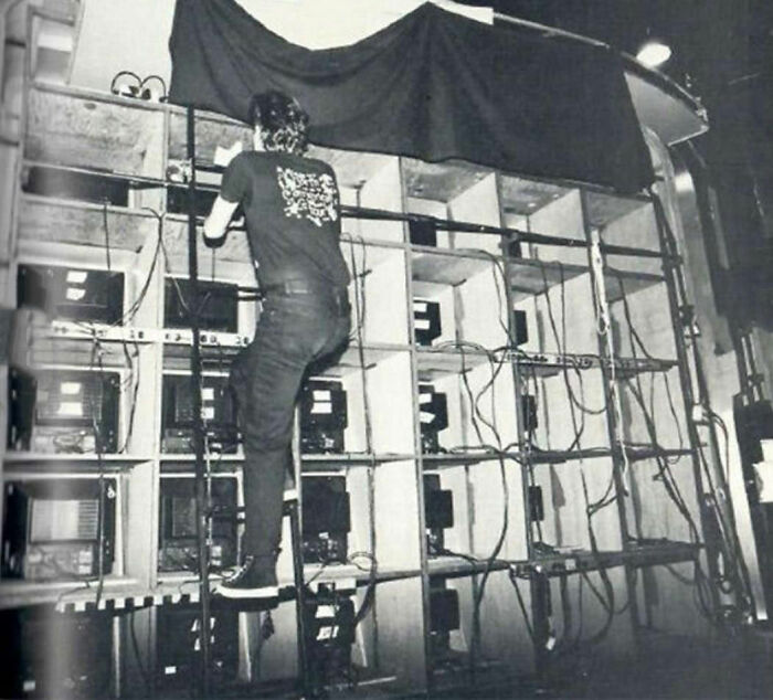 Person working on a complex electronic setup, showcasing a new perspective on famous events and technology from the past.
