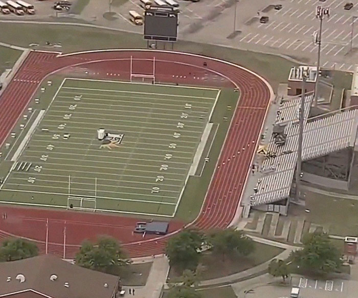 Aerial view of a school football stadium and track, related to a heartbreaking story of a 17-year-old's final moments.