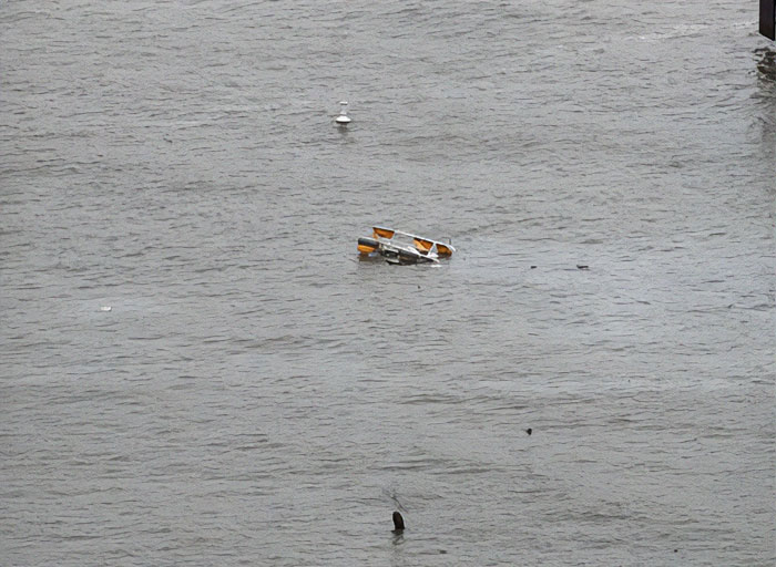 Debris of NYC helicopter crash floating in water.
