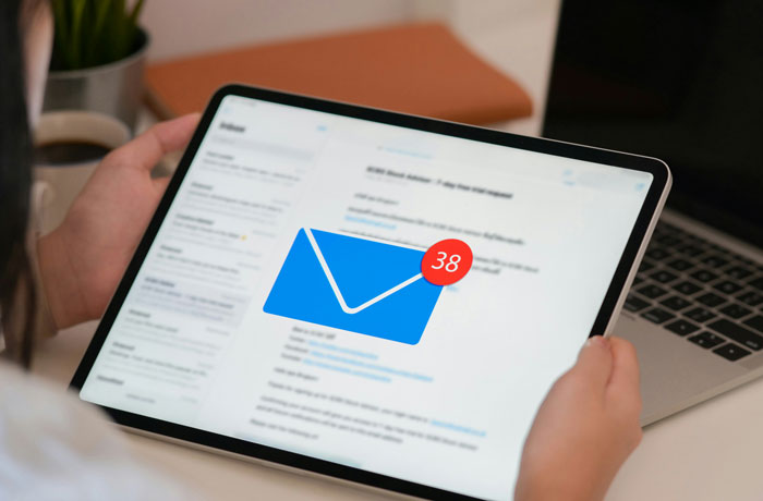 Person using a tablet with an email app open, displaying a notification badge for 38 unread messages as part of internet hacks.
