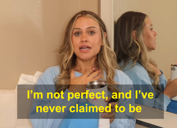 Fitness influencer speaking on weight loss truth, holding a cup, with a reflection in a mirror behind her. Fitness influencer speaking on weight loss truth, holding a cup, with a reflection in a mirror behind her.