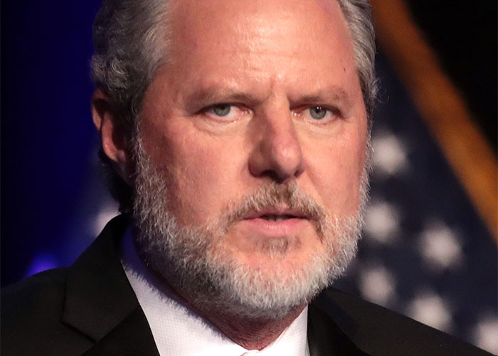 Man with gray beard and suit, part of true wild rumors discussion.