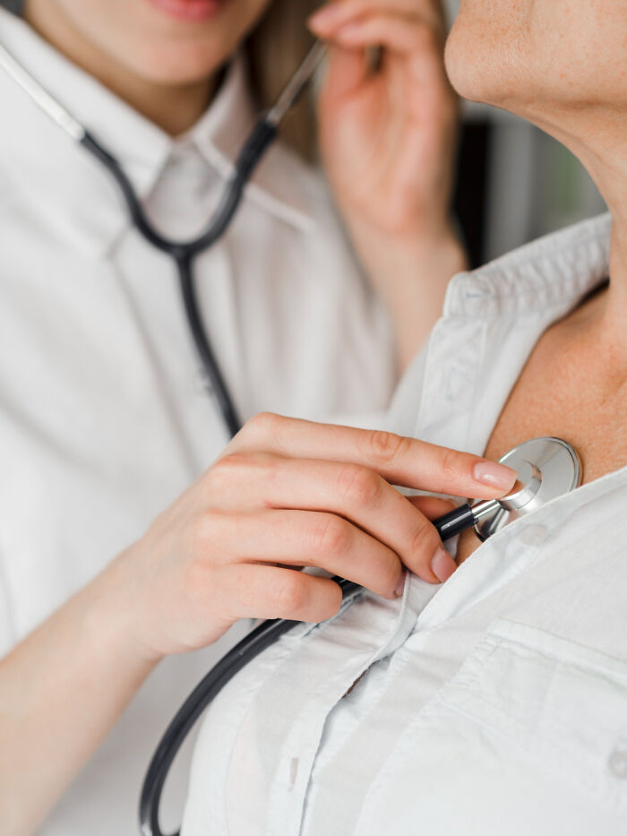 A doctor uses a stethoscope on a patient's chest, symbolizing unexpected lifesaving actions.