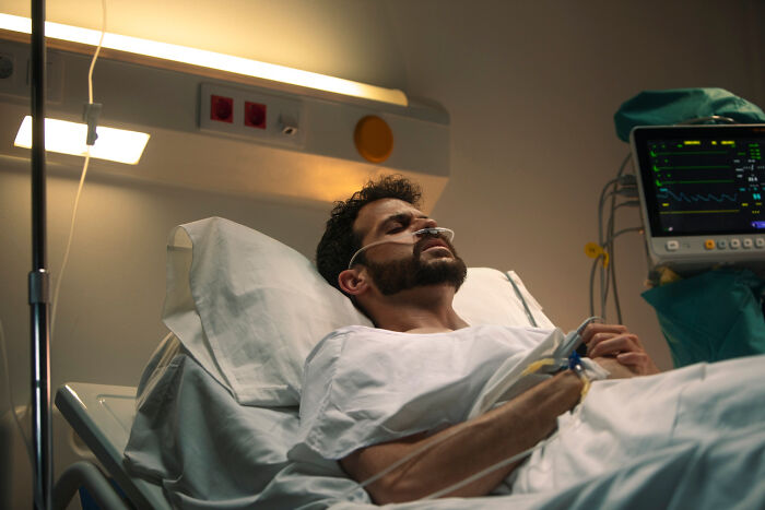 A man in a hospital bed, appearing to have sensed grave danger and trusted his gut instinct.