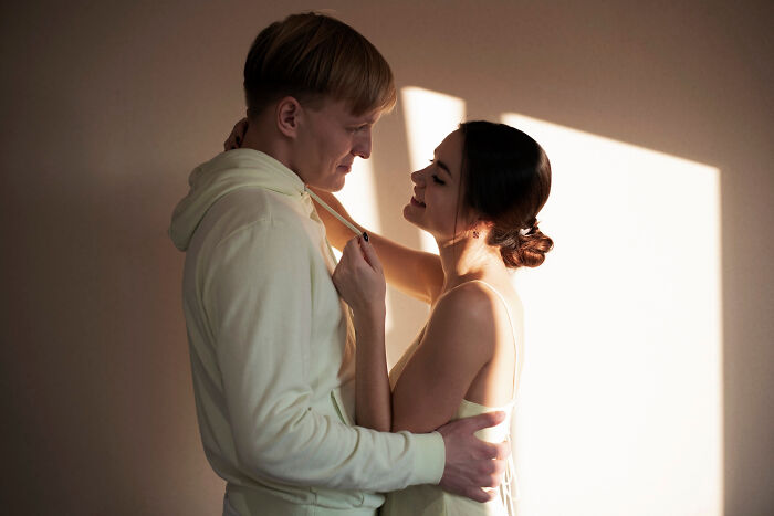 Couple embracing in soft light, representing common assumptions about women.