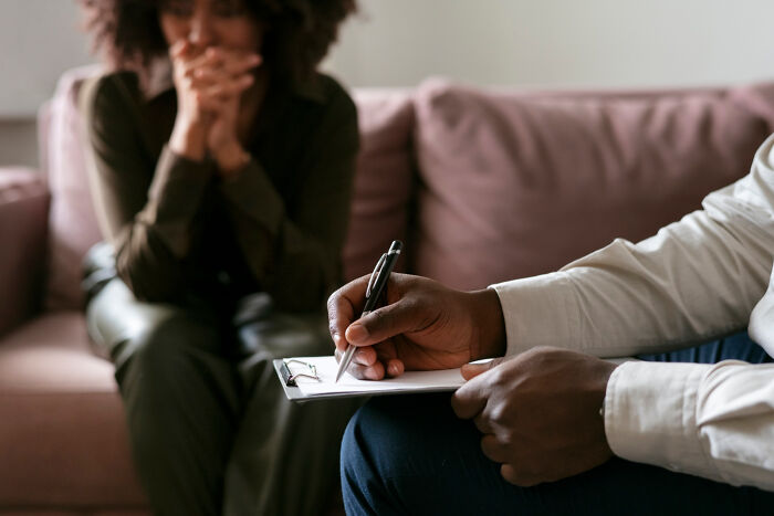 Person writing on a clipboard while another appears worried, illustrating anxiety-inducing concerns that keep people up at night.