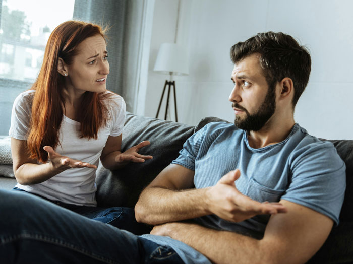 A woman and a man having an intense discussion, illustrating issues with being too close to parents.