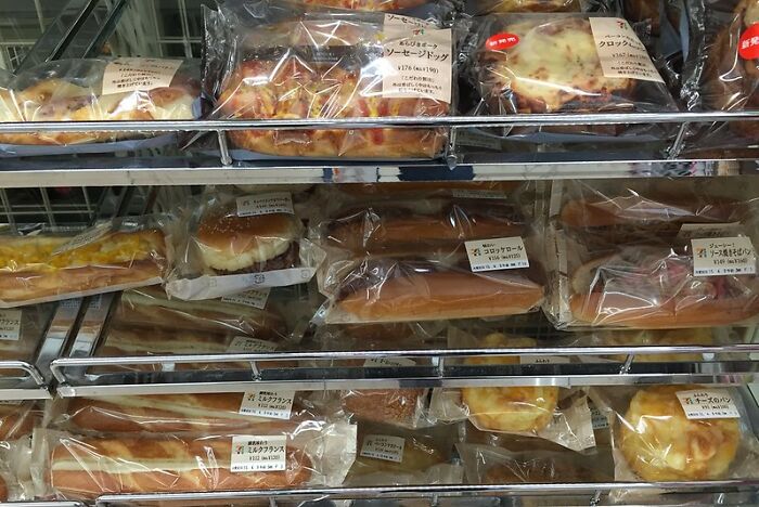 Various packaged restaurant food items displayed on metal racks in a retail setting ready for purchase.