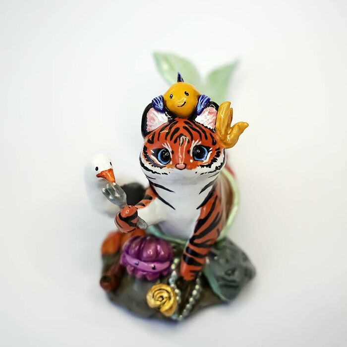 Adorable pocket-sized animal figurine featuring a whimsical tiger with sea accents by Vallavica.