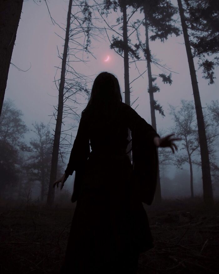 Silhouette in a misty forest under a crescent moon, depicting dreamy dark escapism photography.