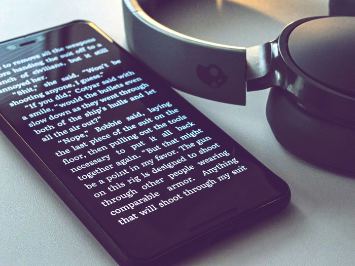 Smartphone displaying text, with headphones nearby, illustrating internet hacks for easier online life.